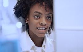 Woman researcher looking at a computer in a lab.